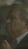 A Thoughtful Executive Lost in Reflection While Surrounded by a Dimly Lit Environment video