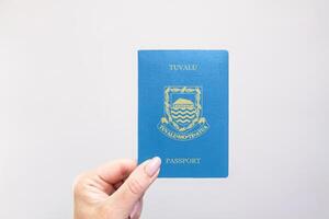 Passport Tuvalu Held Against Simple White Background. Astana, Kazakhstan, 26 october 2024 photo