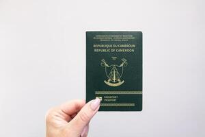Passport Cameroon Held Against Simple White Background. Astana, Kazakhstan, 26 october 2024 photo