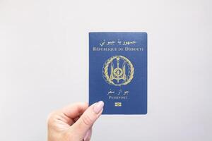Passport Djibouti Held Against Simple White Background. Astana, Kazakhstan, 26 october 2024 photo