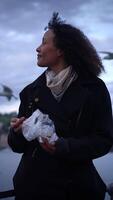 A Thoughtful Woman Holding Plastic Waste in a Beautiful Natural Setting Surrounded by Nature video