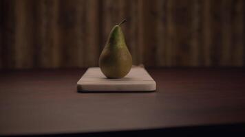 A Fresh Pear Beautifully Presented on a Wooden Cutting Board Ready for Use in Cooking video