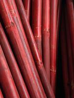 Red Bamboo Poles with Chipped Paint Texture photo