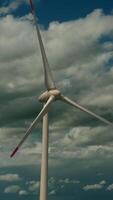 A Wind Turbine in front of a Dramatic Sky Makes for a Fascinating Scene and View video