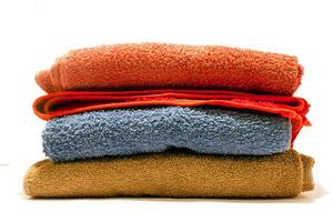 A stack of towels on a white surface photo