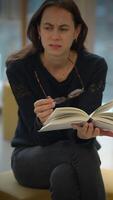 An Engaged Reader Deep in Thought, Immersed in Their Book, Captivated by Every Word video