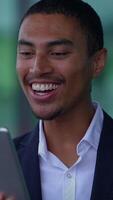 A Smiling Professional Engaging with a Digital Device in a Modern and Trendy Setting video