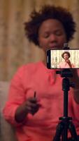 A Content Creator is Recording a using a Smartphone that is placed on a Tripod video