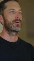 A contemplative man dressed in casual attire, reflecting on life with a calm demeanor video