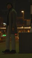 A captivating and mysterious night scene showcasing a stylish figure in a modern setting video