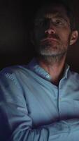 A contemplative man is illuminated by dim light, creating a profound and introspective atmosphere video