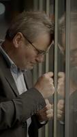 Engaging in Deep Emotional Contemplation by the Window within a Professional Business Setting video