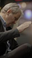 A contemplative man, dressed in a formal suit, is deeply engaged in thought and reflection video