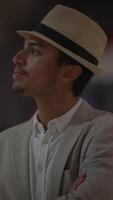 An Elegant Man Wearing a Fedora Hat Attending an Event with a Sophisticated Appearance video