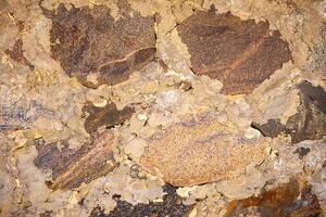 Stone background, rock wall backdrop with rough texture. Abstract, grungy and textured surface of stone material. Nature detail of rocks. photo