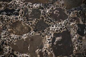 Texture of a stone wall. Old castle stone wall texture background. Stone wall as a background or texture. An example of masonry as a cladding of external photo
