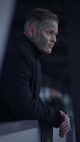 A contemplative man adorned with tattoos immersed in an expressive urban setting and atmosphere video