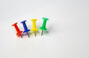 four different colorful push pins isolated on white photo