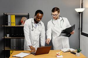 Two men in white lab coats analyzing xray photo