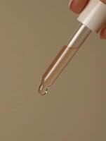 A person holding a small tube with liquid in it photo