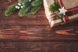 Christmas background with gift box and fir branches. Xmas and New Year theme. Space for text. photo