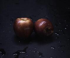 Two red apples with water drops around, photo