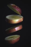 Sliced apple floating in th air,black background, photo
