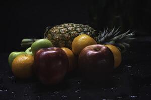 Mixed fruit.there are Pineapple,Apple and orange put on background photo