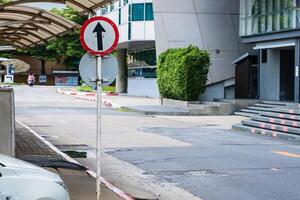 Directional Clarity in Urban Spaces.A Vivid Image of Go Straight Signage Amidst Cityscape at Nonthaburi, Thailand photo