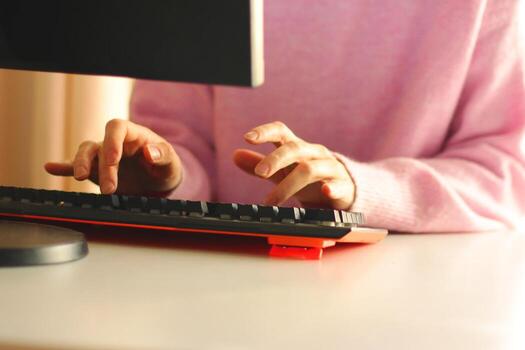 hands typing on the keyboard of a personal computer. work from home, remote work, office work photo