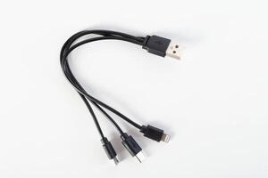 Universal black 3 in 1 charging cable with different charging connectors on a white background, close-up. Type-c, usb-c, micro-usb photo