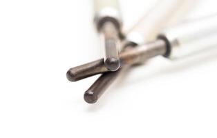 Modern ceramic glow plugs for warming up a diesel engine before starting. White background, isolate. Macro photo