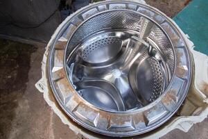 Disassembling the washing machine drum to replace the cross. Washing machine breakdown and repair, close-up photo