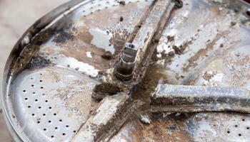 Breakage of the metal cross in the washing machine and non-separable drum. Fault in washing machines, close-up photo