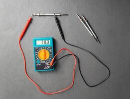 Checking the serviceability of the glow plug with a multimeter. Glow plug voltage resistance. Modern heating element, close-up photo
