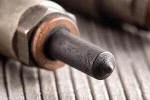 Needles and nozzles on nozzles from a diesel engine. Deterioration of the fuel system of the car, macro photo