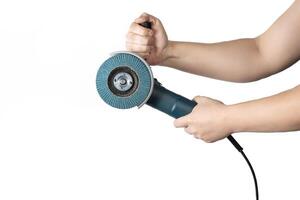 Angle grinder with a petal wheel in the hands of a worker on a white background, isolate.. Sanding wood and metal. photo
