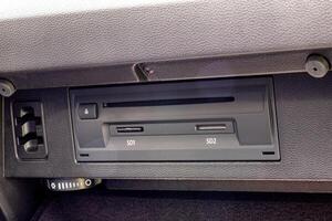 Modern navigation system with memory cards in the glove box of a car, close-up photo