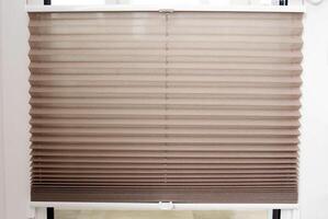 Modern classic aluminum blinds on the window sash with a scaffold fixing system. Protection from prying eyes and the sun. photo