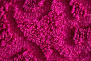 texture of burgundy terry towel with a pattern, close-up. Background, vinous photo