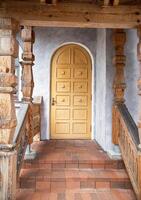 Semicircular wooden door in the entrance building and stone porch with steps, architecture photo