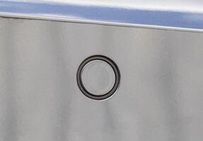 parktronic sensor on the gray bumper of the car. Obstacle distance sensor, macro photo
