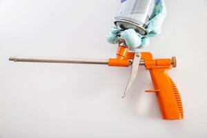 Construction foam gun with a defective cylinder. Foam bottle defect, close-up photo