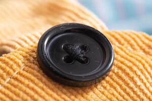 Brown corduroy material with button, macro, textured photo