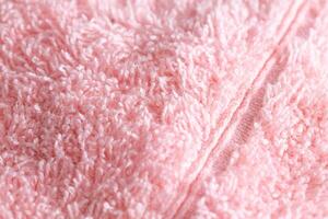 Texture background fabric with pile. Pink soft cloth, macro photo
