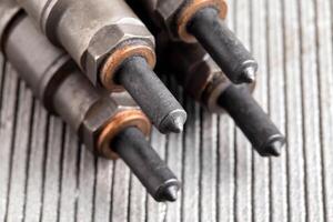 Needles and nozzles on nozzles from a diesel engine. Deterioration of the fuel system of the car, macro photo