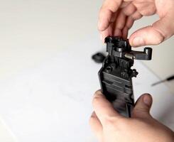 Disassembly of a drum cartridge on a white background. Cleaning and maintaining cartridge parts. Copy space for text photo