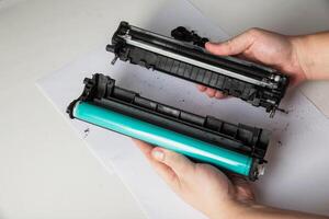 Disassembly of the printer cartridge for its maintenance and refilling with toner. White background, technology photo