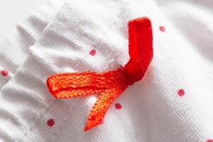 white clothes with red patterns and elastic band, macro photo