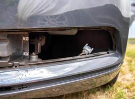 Removed fog lamp from a car to replace a burnt out light bulb. Close-up photo